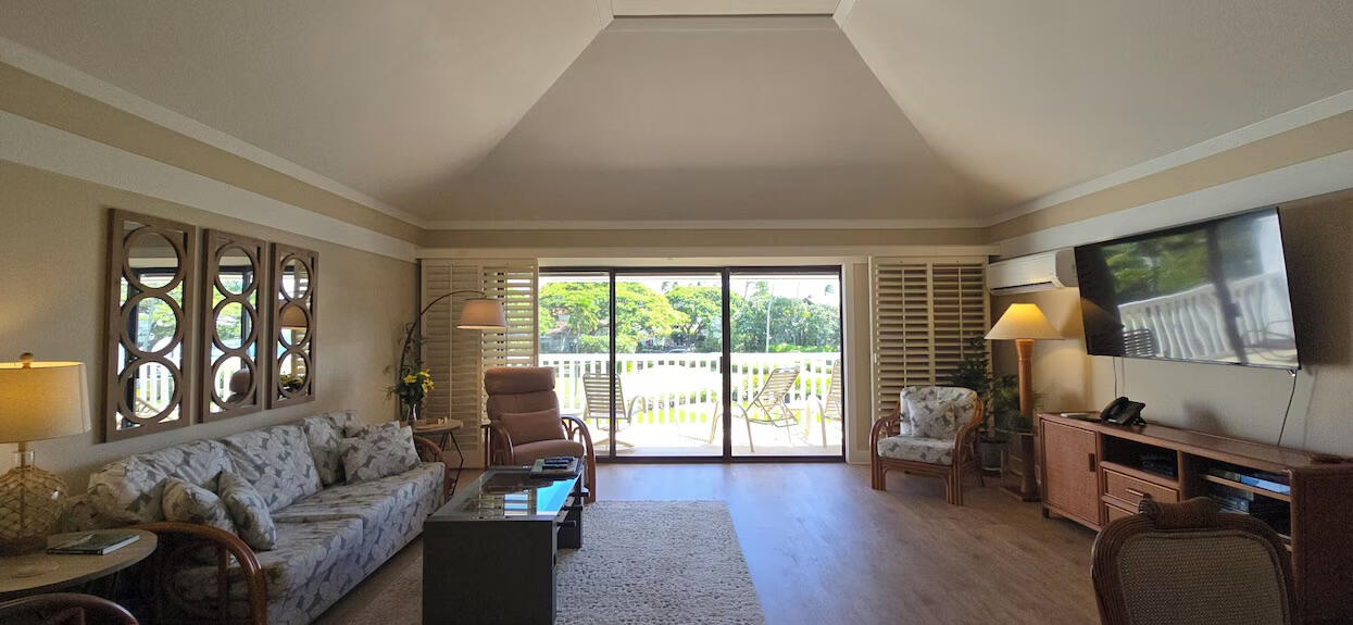 Open living room flowing seamlessly to a spacious ocean-view lanai